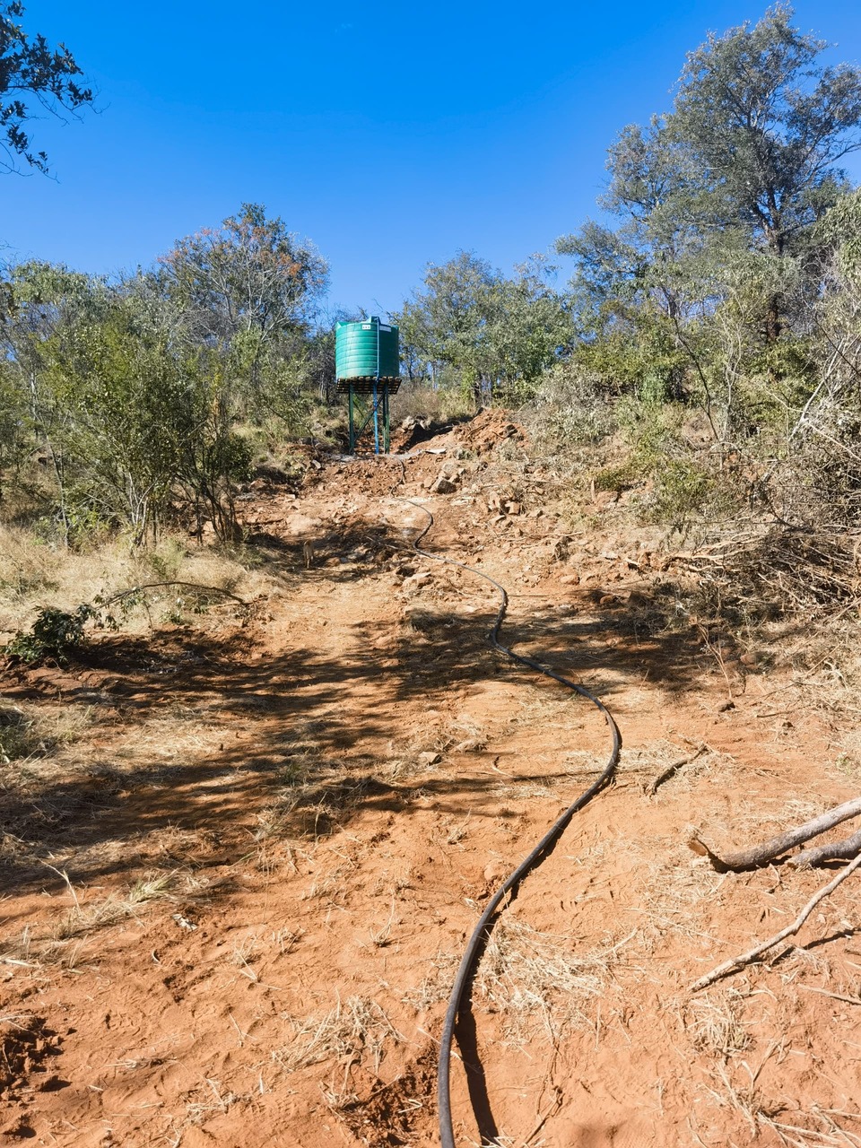 5,000L Makoro tank on black steel stand with blue pipework, Mangoro Mine